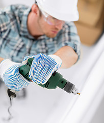 Image showing man drilling the wall