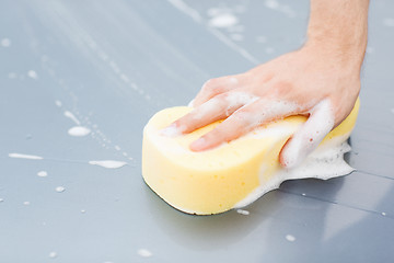 Image showing man washing a car