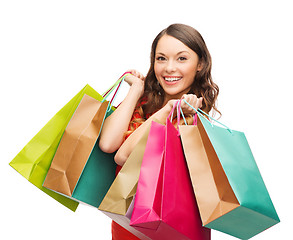 Image showing woman in red dress with shopping bags