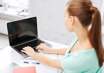 Image showing businesswoman with laptop computer in office