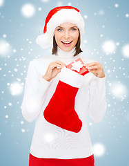 Image showing woman in santa hat with gift box and stocking