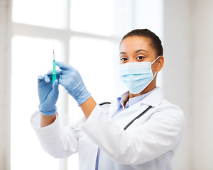 Image showing african doctor holding syringe with injection