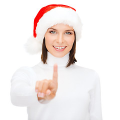 Image showing woman in santa helper hat pressing vitrual button