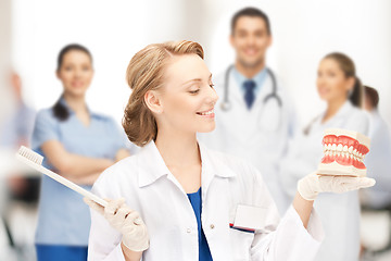 Image showing doctor with big jaws and toothbrush