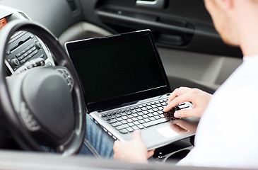 Image showing man using laptop computer in car