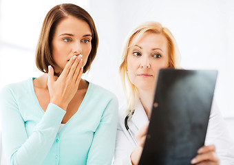 Image showing doctor with patients looking at x-ray