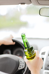 Image showing man drinking alcohol while driving the car