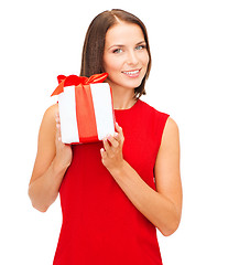 Image showing smiling woman in red dress with gift box