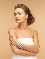 Image showing beautiful woman with pearl earrings and bracelet