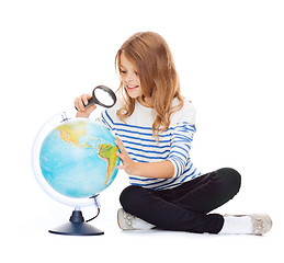 Image showing child looking at globe with magnifier