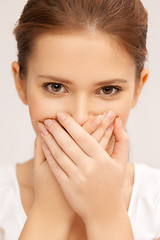 Image showing face of beautiful teenage girl covering her mouth