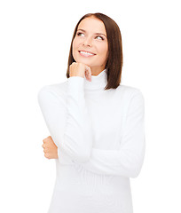 Image showing thinking and smiling woman in white sweater