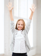Image showing student girl with hands up at school