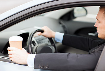 Image showing man drinking coffee while driving the car