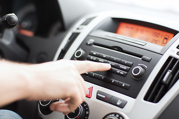 Image showing man using car audio stereo system