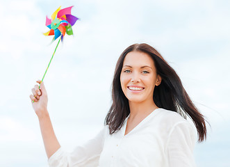 Image showing girl with windmill toy on the beach