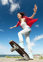 Image showing teenage girl skating outside