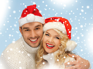 Image showing family couple in sweaters and santa's hats