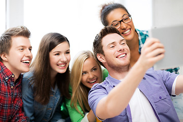 Image showing students making picture with tablet pc at school