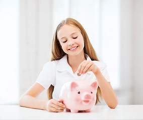 Image showing child with piggy bank