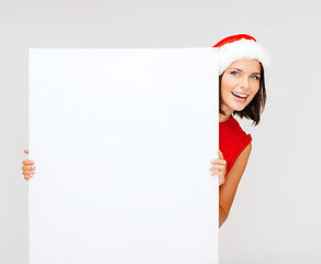 Image showing woman in santa helper hat with blank white board