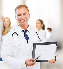 Image showing male doctor with stethoscope showing cardiogram