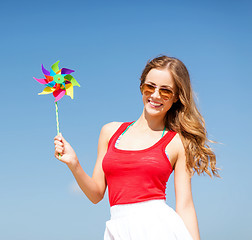 Image showing girl with windmill toy on the beach