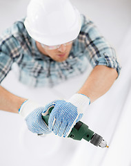 Image showing man drilling the wall