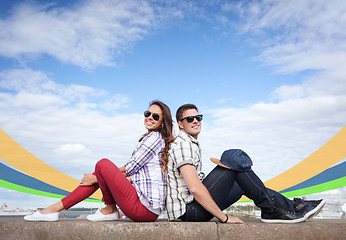 Image showing teenagers sitting back to back