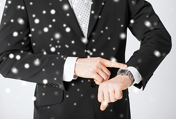 Image showing man looking at wristwatch