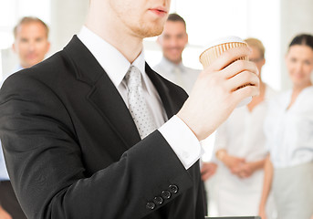 Image showing man hand holding take away coffee