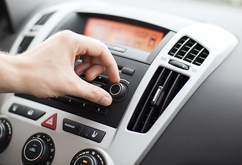 Image showing man using car audio stereo system
