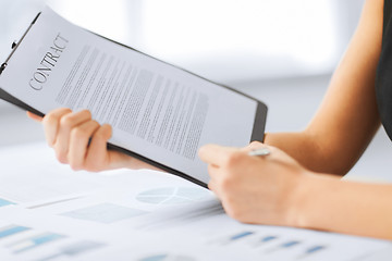 Image showing woman hand signing contract paper