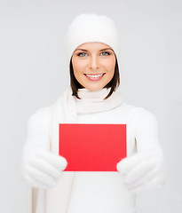 Image showing woman in winter clothes with blank red card