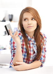 Image showing pensive teenage girl with credit card