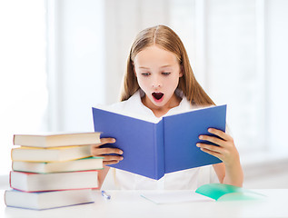 Image showing girl studying and reading book at school