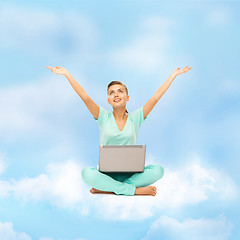 Image showing woman sitting on the cloud with laptop