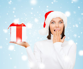 Image showing surprised woman in santa helper hat with gift box