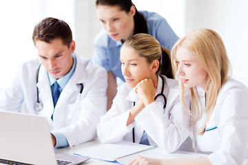 Image showing group of doctors looking at tablet pc