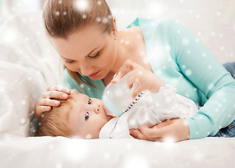 Image showing mother and adorable baby with feeding-bottle