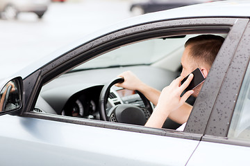 Image showing man using phone while driving the car