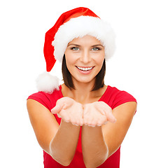 Image showing woman in santa helper hat with something on palms