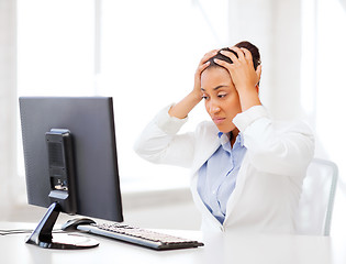 Image showing stressed african woman with computer