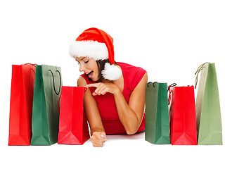 Image showing woman in red shirt with shopping bags