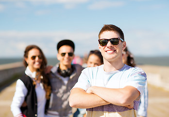 Image showing teenager in shades outside with friends