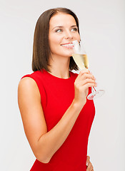 Image showing woman in red dress with a glass of champagne