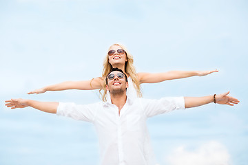 Image showing couple holding hands up at sea side