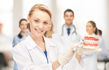 Image showing doctor with big jaws and toothbrush