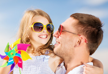 Image showing happy father and child in sunglasses over blue sky