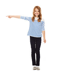 Image showing cute little girl pointing to the side